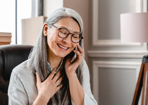 A middle-aged woman talking on the phone
