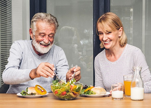 An elderly couple eating a healthy breakfast together