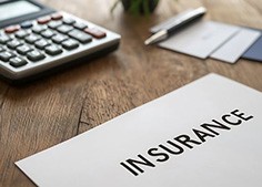 Insurance document next to calculator