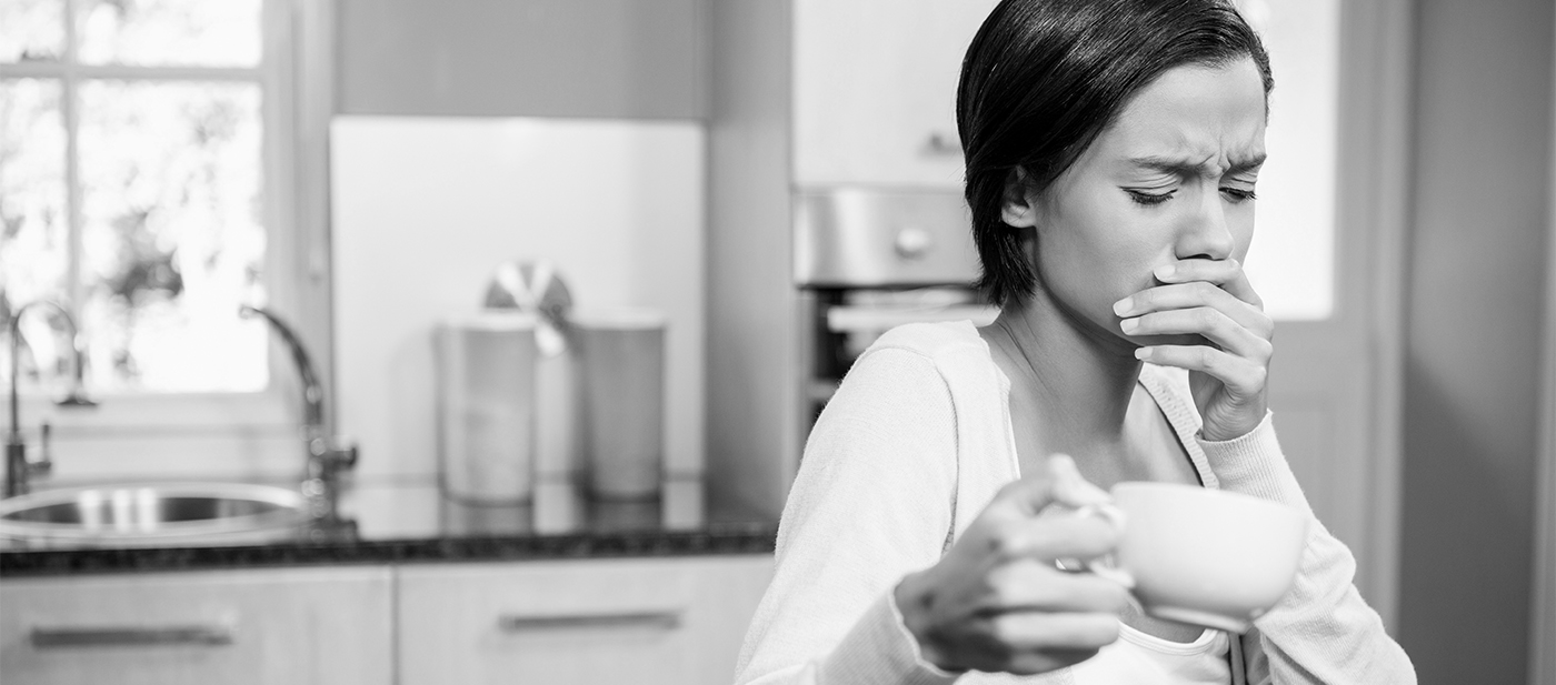 Woman in need of emergency dentistry covering her mouth