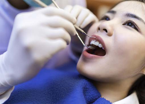 Woman receiving dental checkup in North Andover
