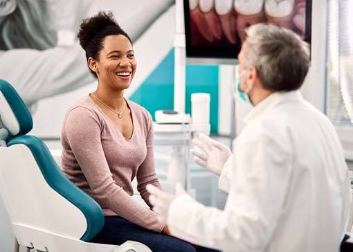 Woman listening to dentist in North Andover