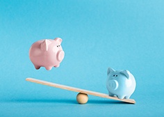 Piggy banks on balance scale