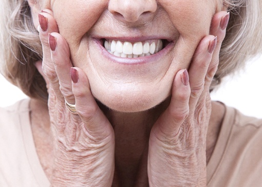 Senior woman smiling with dentures in North Andover