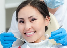 Dentist examining patient with a cut lip