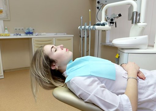 Reclined dental patient with closed eyes
