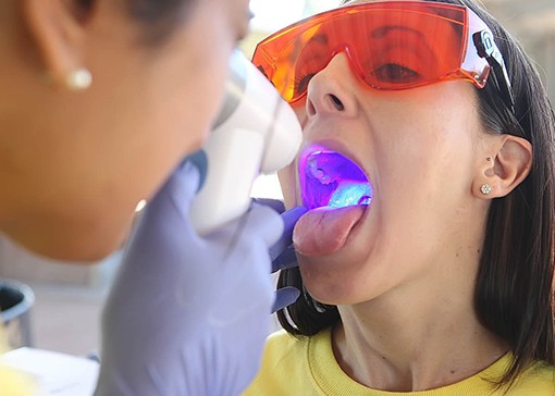 Woman receiving oral cancer screening