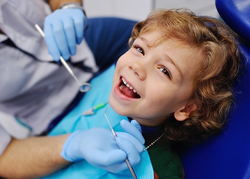 Little boy laughing during children's dentistry visit