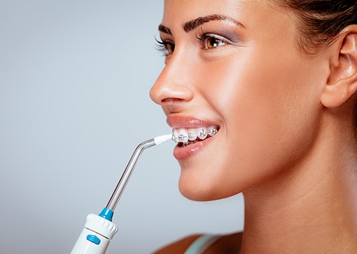Woman using a water flossing tool