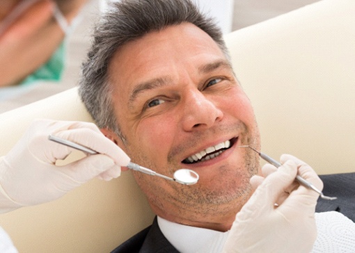 Man smiling after getting tooth-colored filling in North Andover