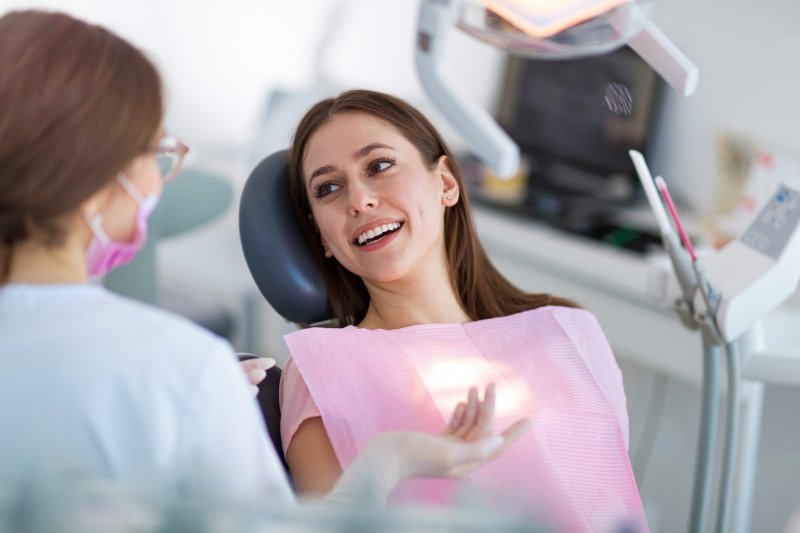 dentist explaining black line around dental crown to patient