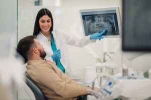 Dentist showing patient his X-ray. 